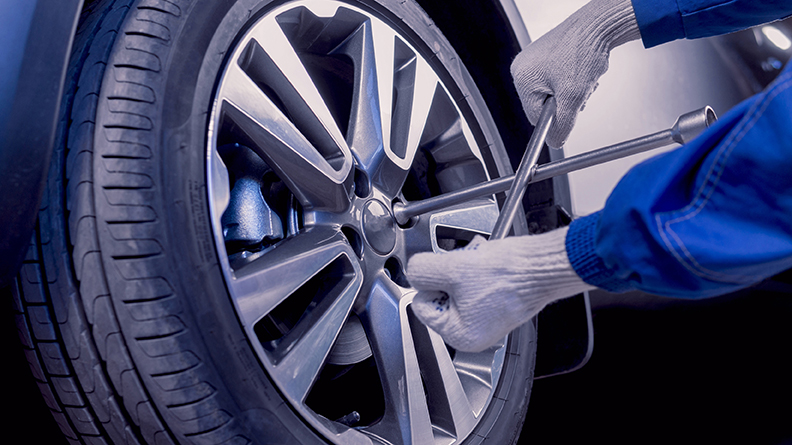 A set of car tyre rims being replaced