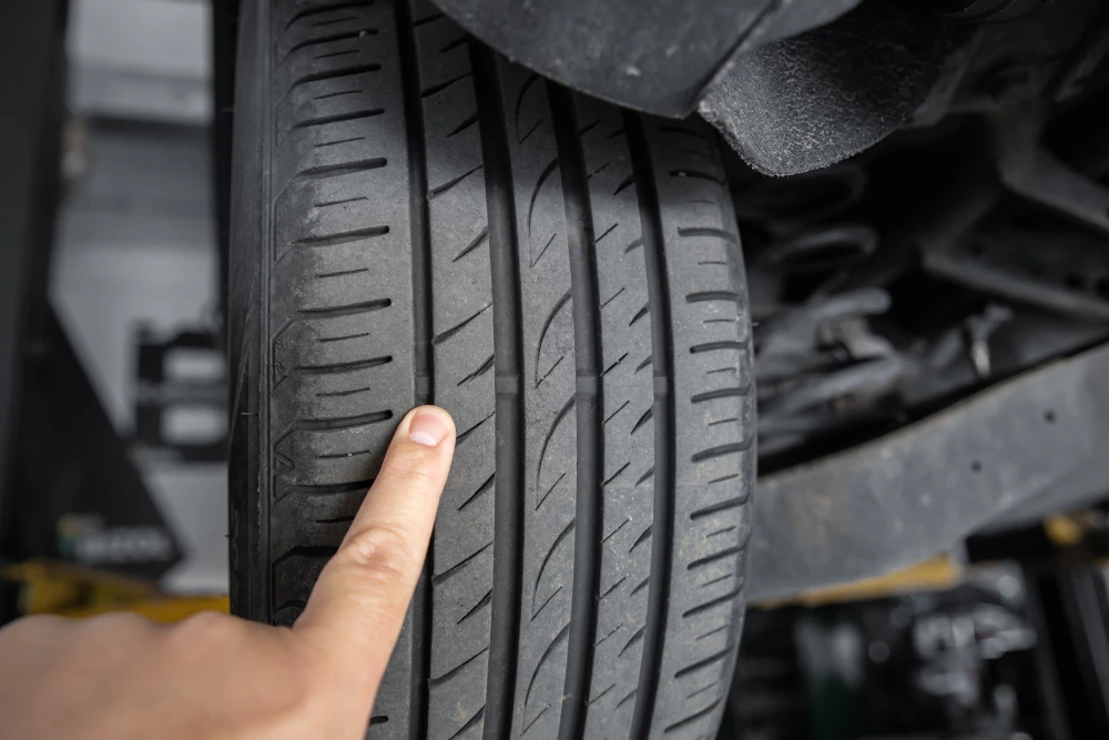 Car mechanic showing tyre wear