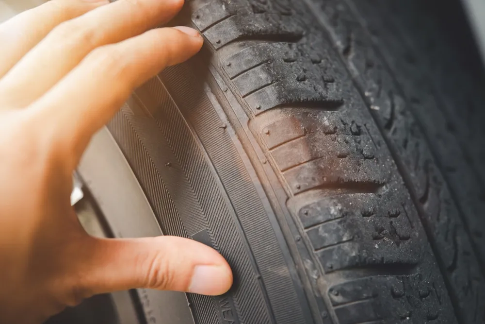 Close-up of the tread of a worn tyre.